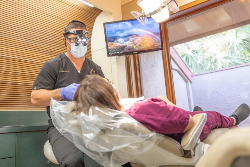 Doctor Nawrocki performing an oral cancer screening in Ormond Beach on a dental patient