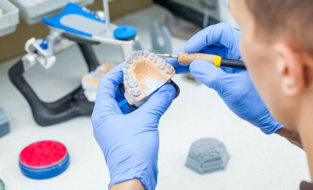 Dental laboratory technician working on dentures