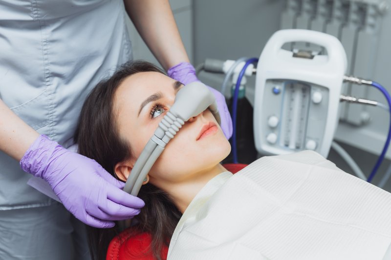 A woman being put under dental sedation for treatment