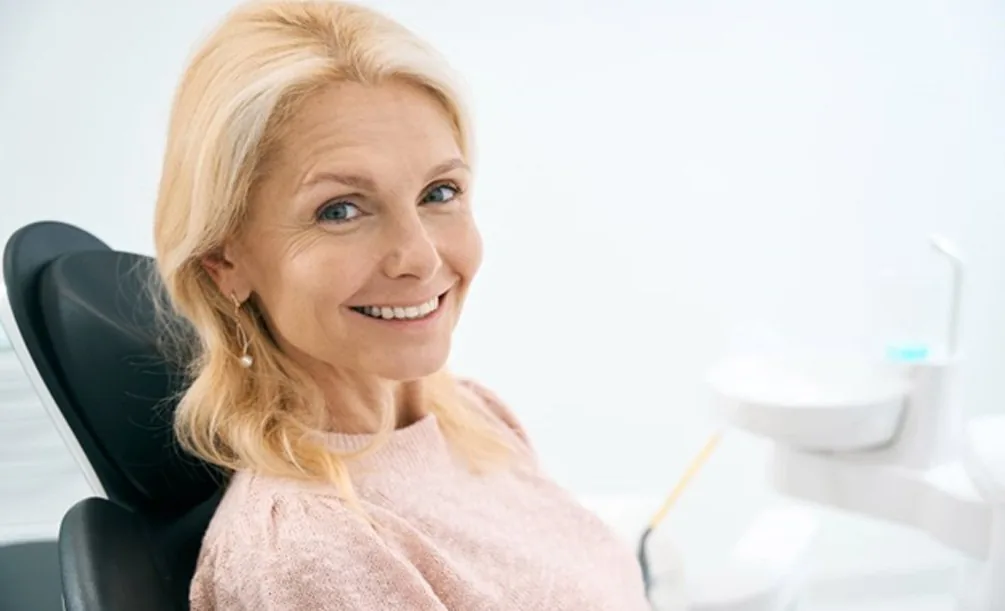 Woman smiling after receiving All-on-6 dental implants
