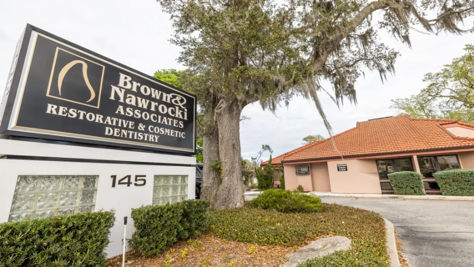 Brown and Nawrocki Restorative and Cosmetic Dentistry office building with sign out front