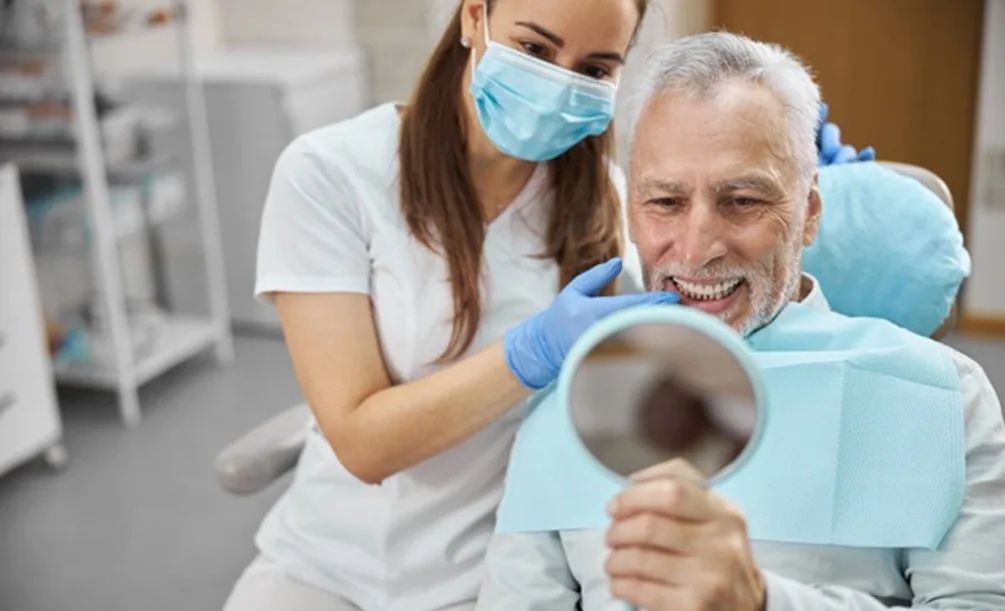 Dental patient checking their smile in a mirror