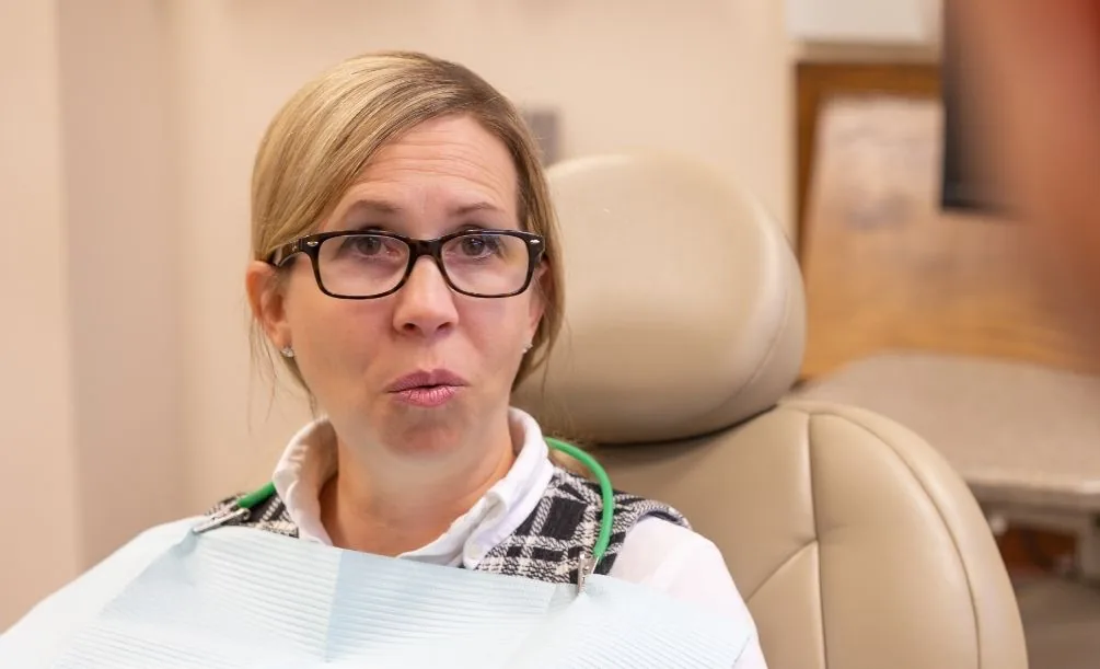 Woman sitting in a dental chair during a checkup