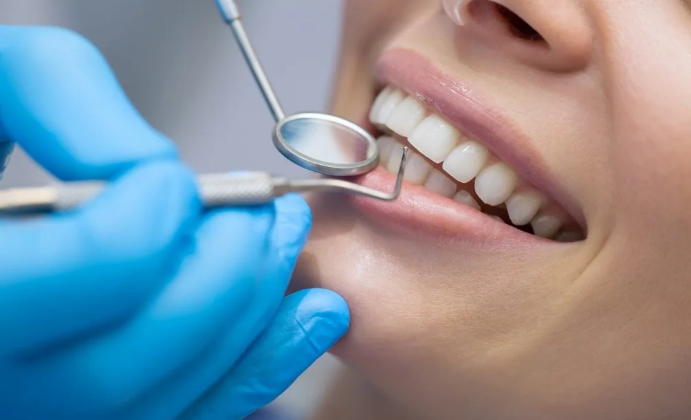 Person having their teeth examined by a dentist