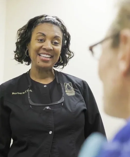 Dental team member examining a patient during a procedure