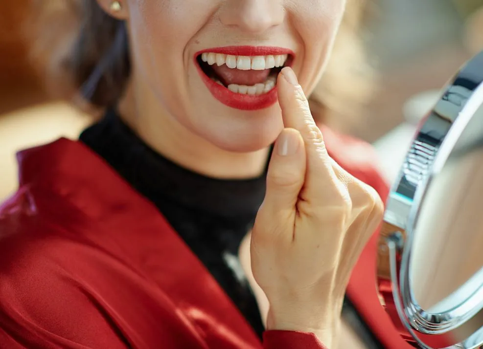 Woman pointing to her tooth