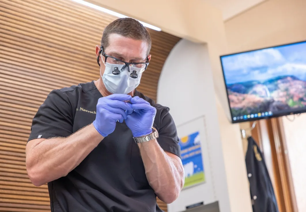 Doctor Nawrocki shaping a dental implant