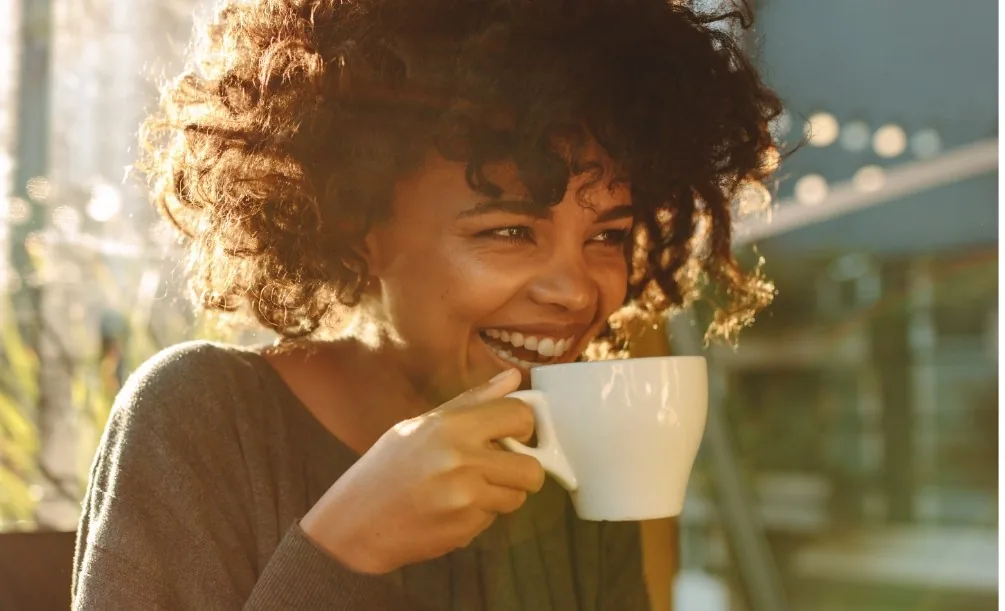 Woman holding a white coffee mug