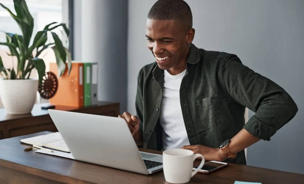 Man sitting at a desk with a laptop