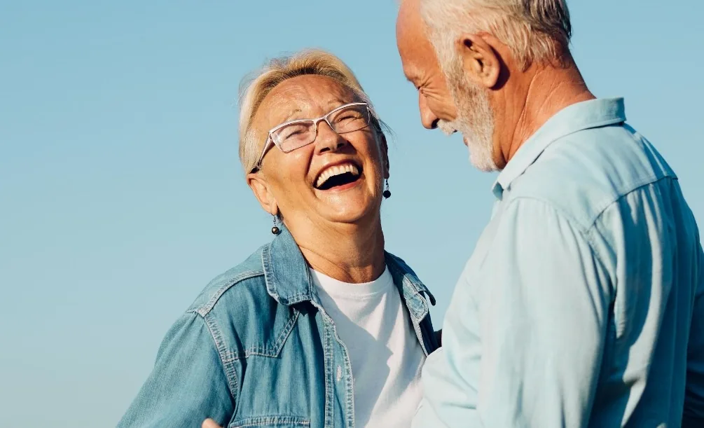 Senior couple laughing together outdoors