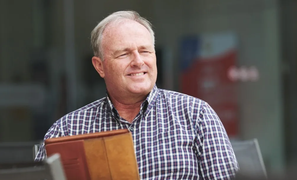 Older man sitting near a window