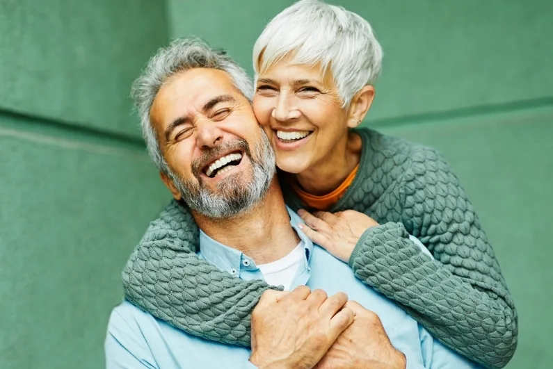 Smiling older man and woman with dentures