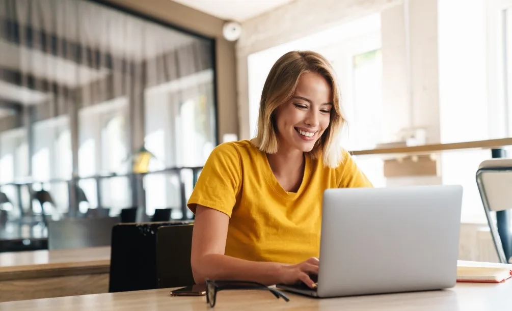 Woman reviewing insurance information on a laptop
