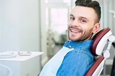 Male patient smiling in a dental chair