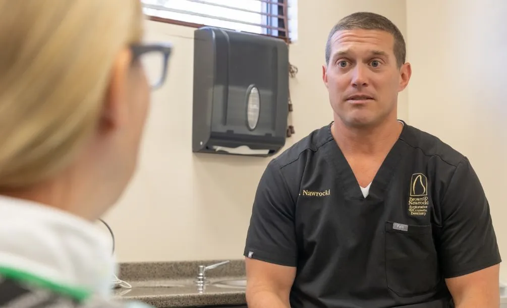 Dr. Nawrocki discussing treatment with a dental patient