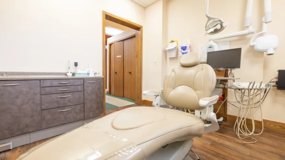 Dental treatment room with a hallway visible through an open door