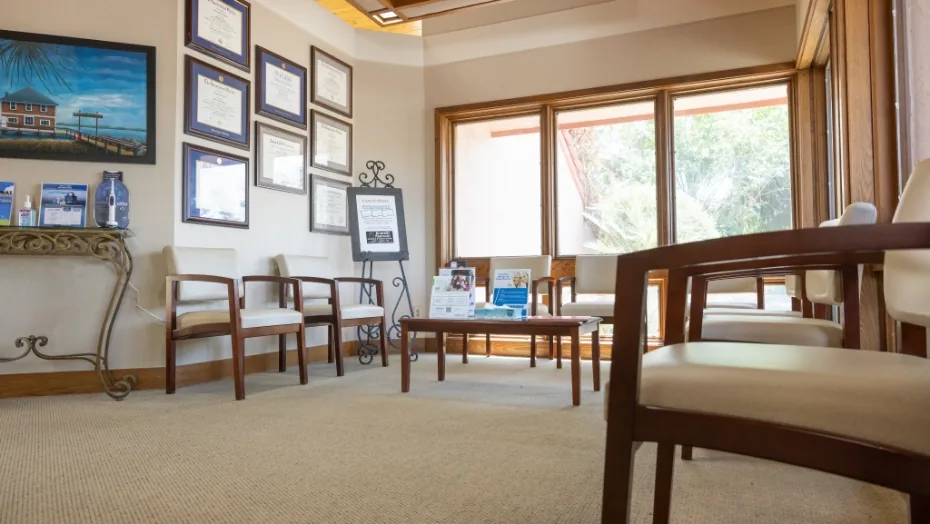 Wooden chairs and table in the dental office waiting room