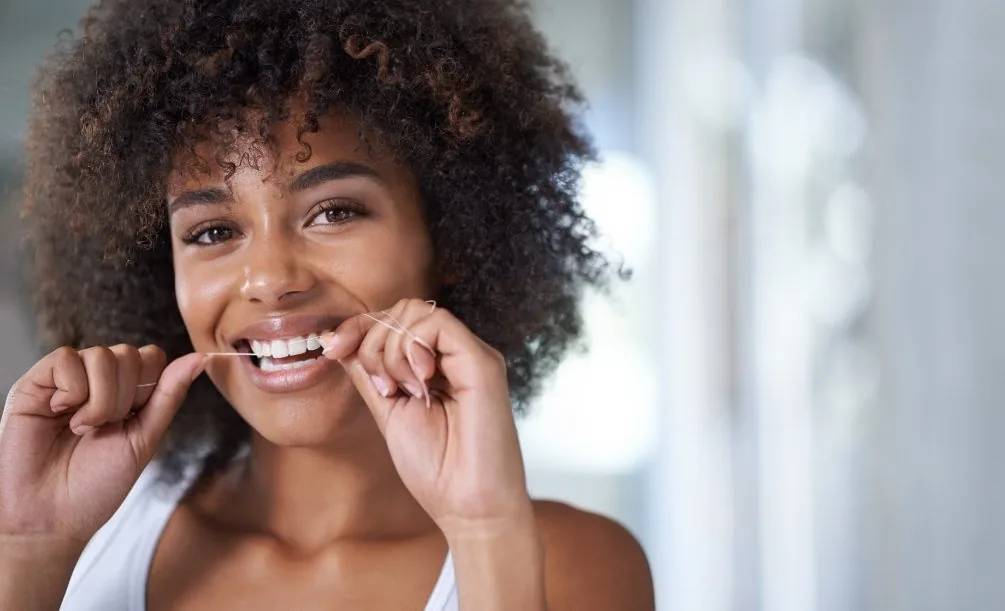 Woman flossing her teeth